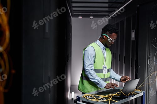 Preview: Young network technician repairing servers in data center