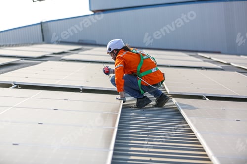 Preview: Workers Installing Solar Panels on warehouse Roof.