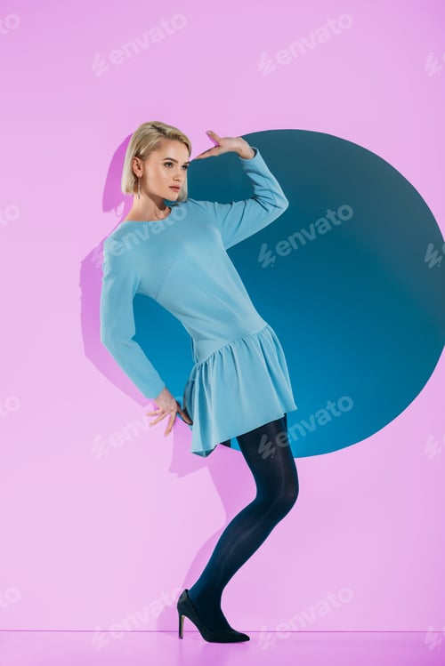Preview: beautiful girl in fashionable clothes posing on pink