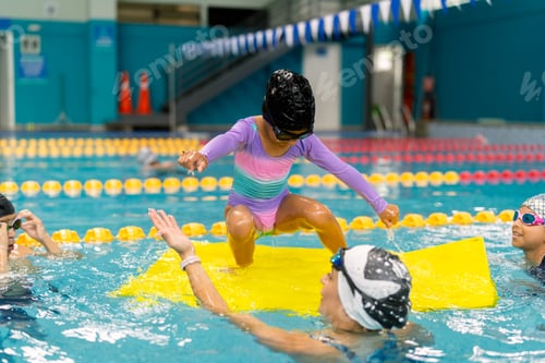 Preview: Child learning swimming techniques during summer lesson