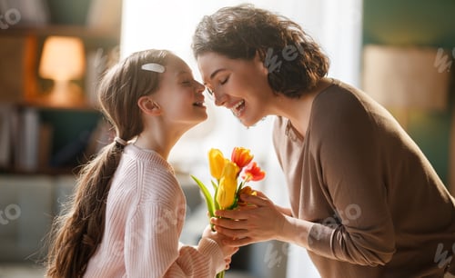 Preview: Happy Mother and Daughter Sharing Tender Moment with Bouquet of Tulips in Cozy Home