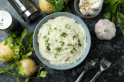 Preview: Concept of tasty eating with mashed potatoes on black smokey table