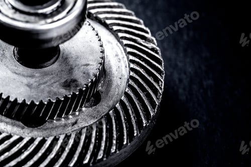 Preview: Close view of metal gear part with grooves and teeth on dark background
