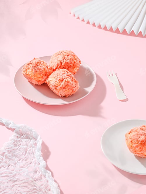 Preview: Three strawberry snowballs in a porcelain bowl and single one served in white plate on a pink table
