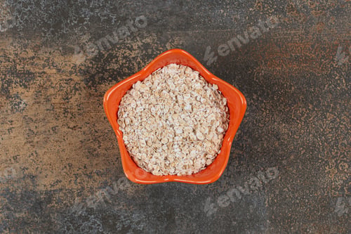 Preview: Delicious oat flakes in orange bowl