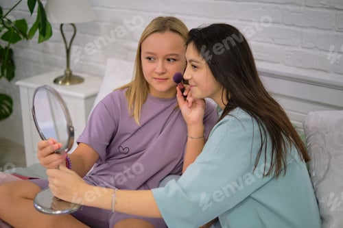 Preview: friends putting makeup on together in the bathroom. Children's pajama party.
