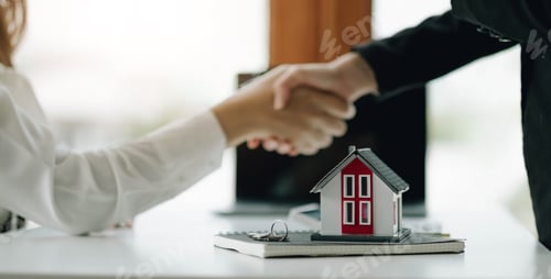 Preview: construction worker shaking hands with customer after finishing up business meeting to start up