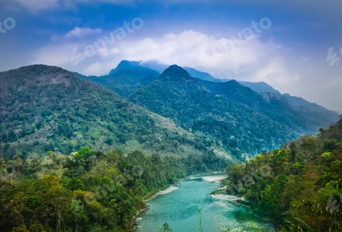 Preview: Beautiful shot of a river surrounded by green mountains in Bhutan