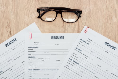 Preview: top view of print resume templates and glasses on wooden table