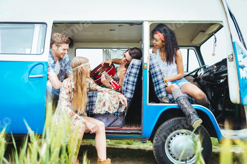 Preview: Happy friends driving a vintage minivan