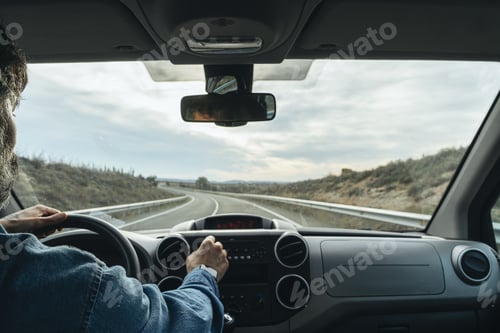 Preview: Man driving a van in an empty street during the daytime