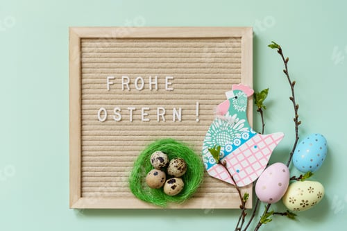 Preview: Happy Easter in german greeting, Easter eggs and green branches on a green background.