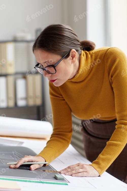 Preview: Female Engineer Inspecting Plans