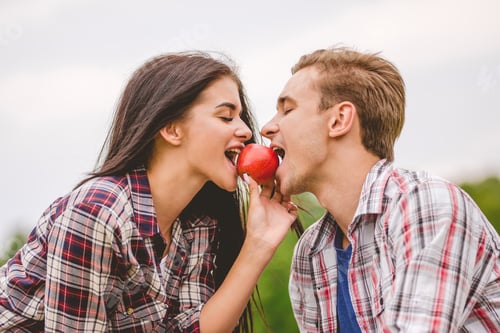 Preview: The man and woman bit an apple