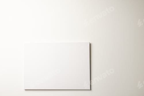 Preview: White canvas and copy space hanging in white wall background