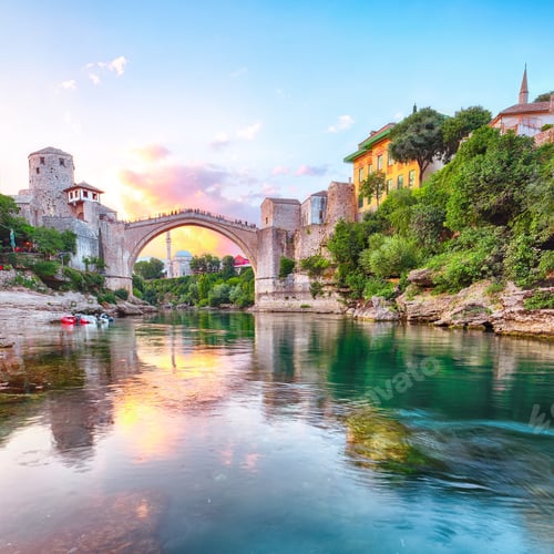 Preview: Fantastic Skyline of Mostar with the Mostar Bridge, houses and minarets, at sunset