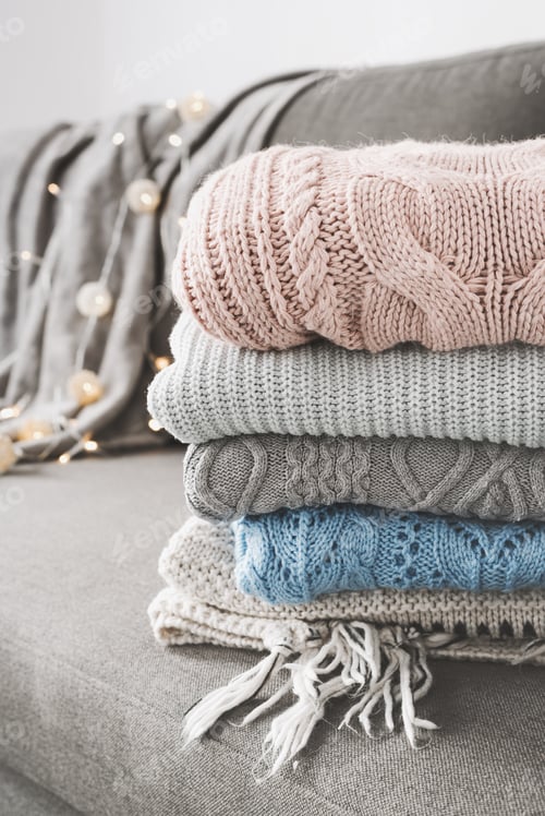 Preview: Folded Knitted Sweaters on Couch with Lights