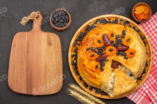 Preview: top view shakh plov delicious rice meal cooked inside round dough with raisins on a dark grey