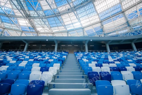 Preview: Cement stairs and blue seats inside football stadium