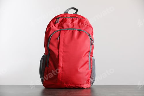 Preview: Red backpack on grey table against light background
