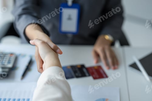 Preview: Young businesswoman, company worker shaking hands congratulating customer approved credit card and c