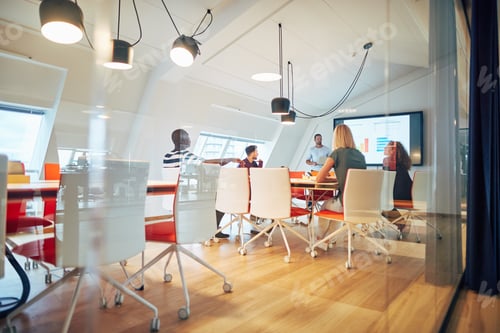 Preview: Manager giving a monitor presentation to office colleagues