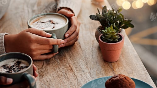 Preview: Cropped shot of an unrecognizable woman having coffee with her female friend at a coffee shop