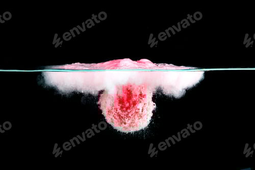 Preview: Plum falling into the water with a splash against black background