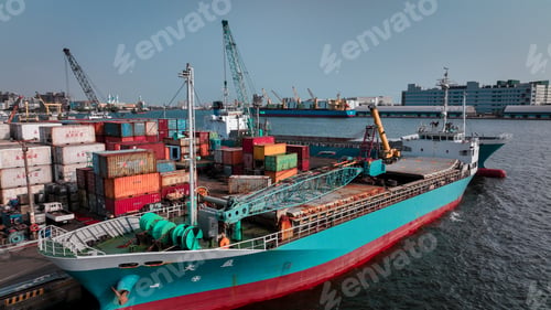 Preview: Container ship unloading cargo containers at Kaohsiung port during sunny day in Taiwan