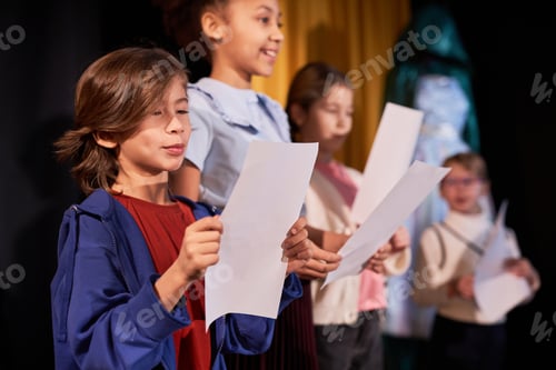 Preview: Boy Standing on Stage in School Theater
