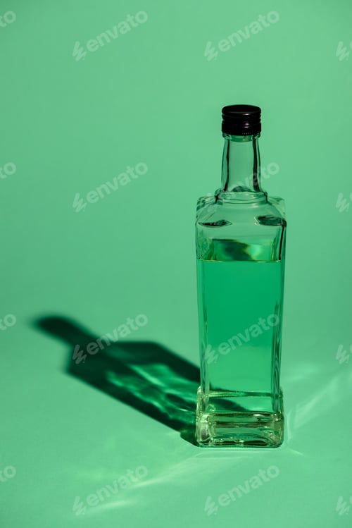 Preview: glass bottle of absinthe on green surface