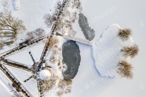 Preview: an island on a lake with a bridge in the Winter Loshitsky Park. Minsk, Belarus