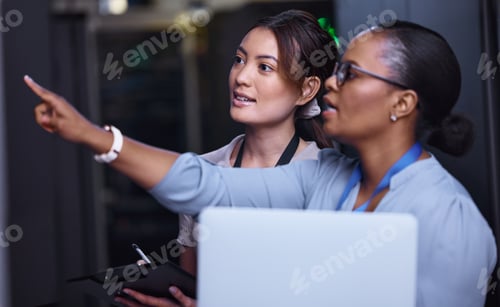 Preview: Cropped shot of two attractive young female computer programmers working together in a server room