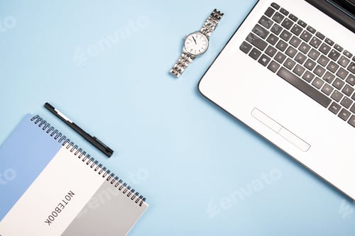 Preview: Top view of an open notebook, a notepad, a pen, and a watch on a blue background