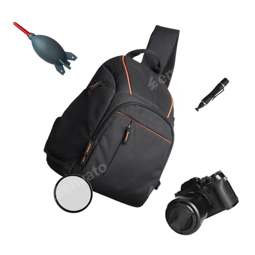 Preview: Photographer's backpack and professional equipment flying against white background