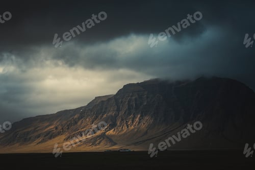 Preview: Dramatic storm clouds over large mountain in Iceland