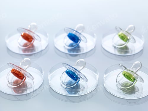 Preview: A colorful array of pacifiers neatly aligned on a reflective surface.