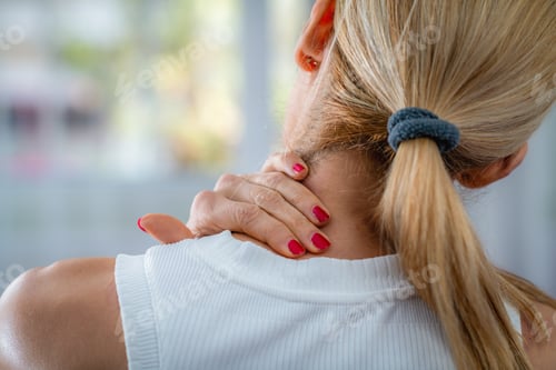 Preview: Neck pain is indicated by a woman rubbing her neck with her hand.