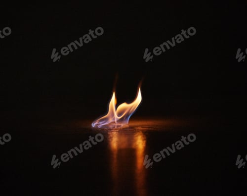 Preview: Beware of burning passion. Studio shot of a small flame burning against a black background.