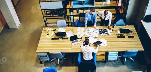 Preview: Top view on diversity crew of experienced economists brainstorming during working process in office
