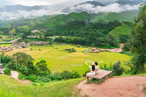 Preview: Young happy couple tourist enjoying and relaxing with beautiful landscape view rice paddy field