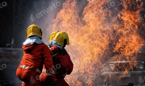 Preview: fire fighter team on training with gas and oil fire hold hose spray jet water spray to extinguish