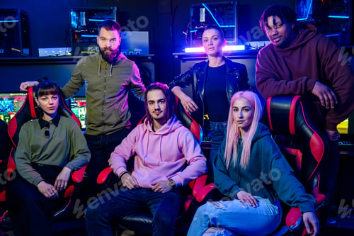 Preview: Diverse team of gamers posing while looking at the camera in gameroom