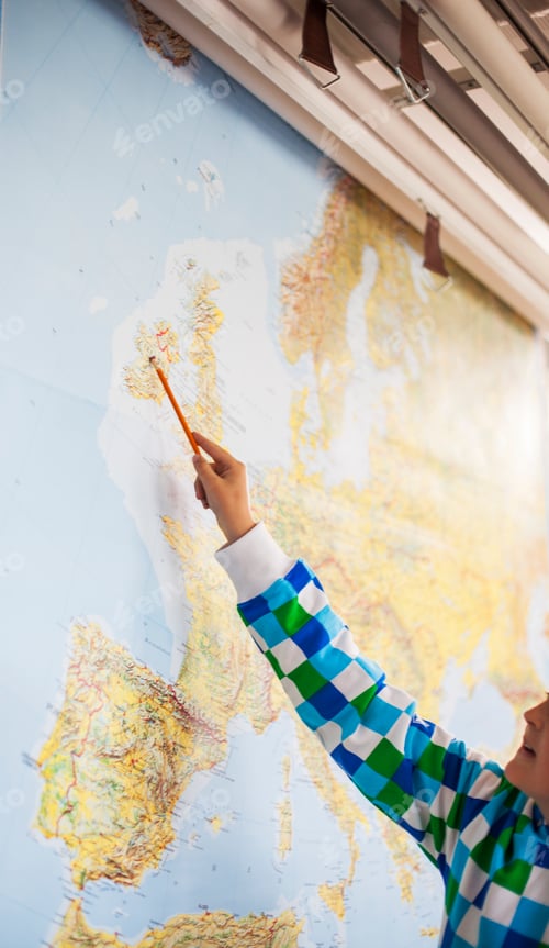 Preview: Cropped image of student pointing at map with pencil in classroom