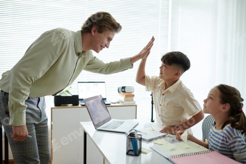 Preview: Teacher High-Fiving Student During Classroom Activity