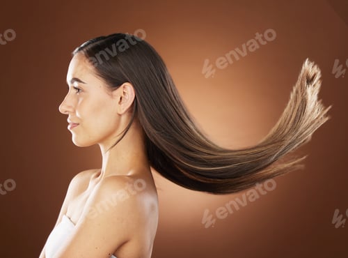 Preview: Hair, beauty and skincare with a model woman in studio on a brown background for natural or keratin