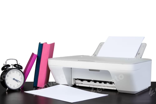 Preview: Printer and stack of books on black table against white background
