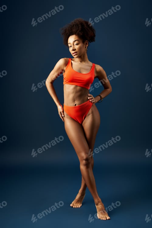 Preview: Vibrant Pose: Woman in Orange Bikini on Blue