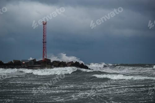Preview: Heavy storm at the gates to the port of Klaipeda, Lithuania. Baltic Sea against a gray cloudy sky