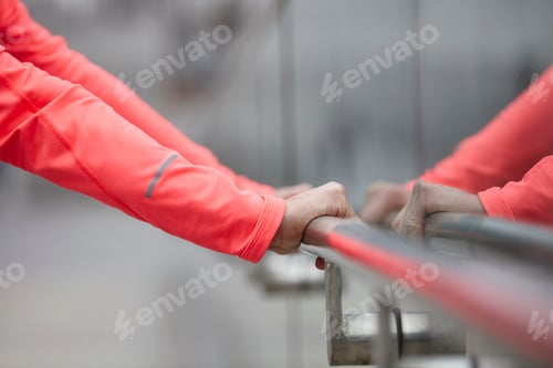 Preview: Hands of mature woman training, holding city handrail